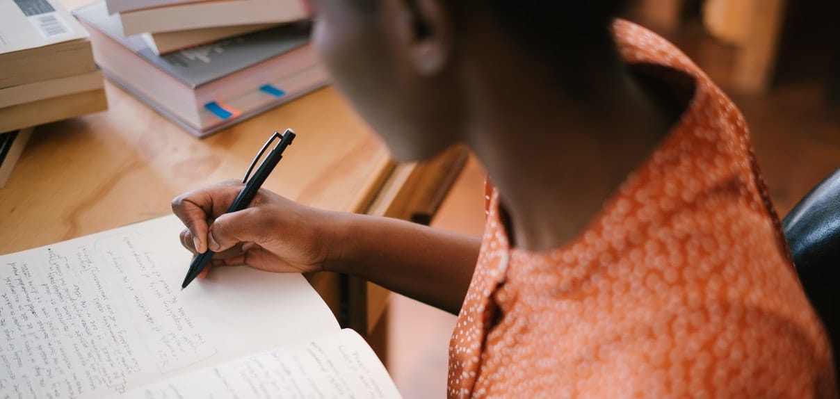 black woman writing on a notepad