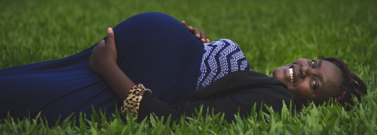 Pregnant woman in a grass field